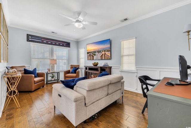 living area featuring ornamental molding, wood-type flooring, and visible vents