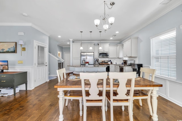 dining area with recessed lighting, a wainscoted wall, ornamental molding, dark wood finished floors, and an inviting chandelier