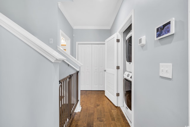 hallway with crown molding, dark wood finished floors, and stacked washer / drying machine