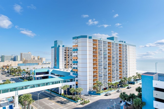 view of building exterior featuring a water view and a city view