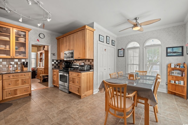 4306 Windy Heights Dr, North Myrtle Beach, SC 29582 - kitchen featuring wallpapered walls, stainless steel appliances, ornamental molding, a ceiling fan, and dark countertops