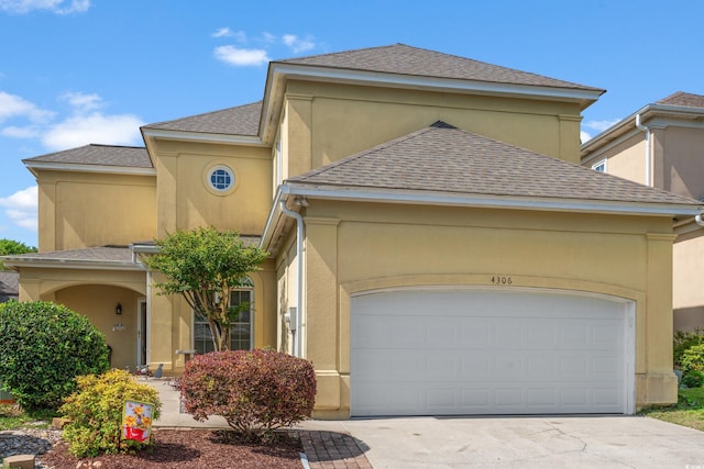 4306 Windy Heights Dr, North Myrtle Beach, SC 29582 - view of front of home with driveway, stucco siding, an attached garage, and roof with shingles