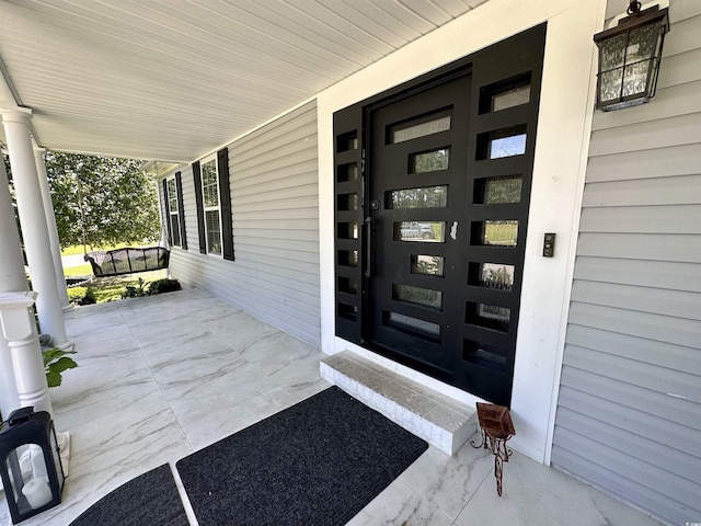 entrance to property featuring a porch