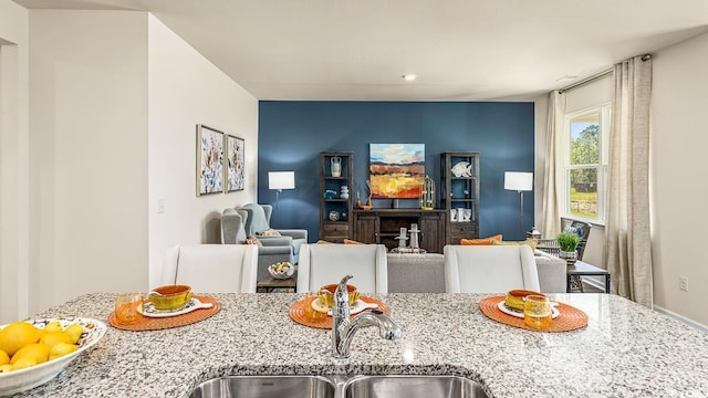 interior space featuring light stone countertops and a sink