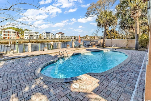 view of swimming pool featuring a fenced in pool, a patio, and a fenced backyard