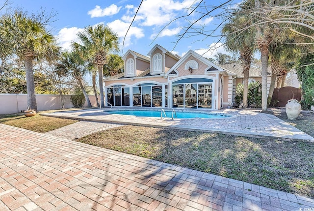 back of house featuring a patio, a fenced backyard, and a fenced in pool