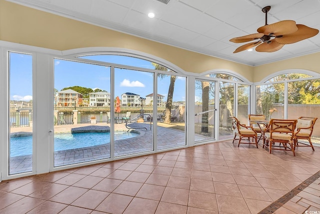 sunroom featuring ceiling fan