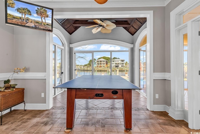 game room with baseboards, a ceiling fan, and vaulted ceiling with beams