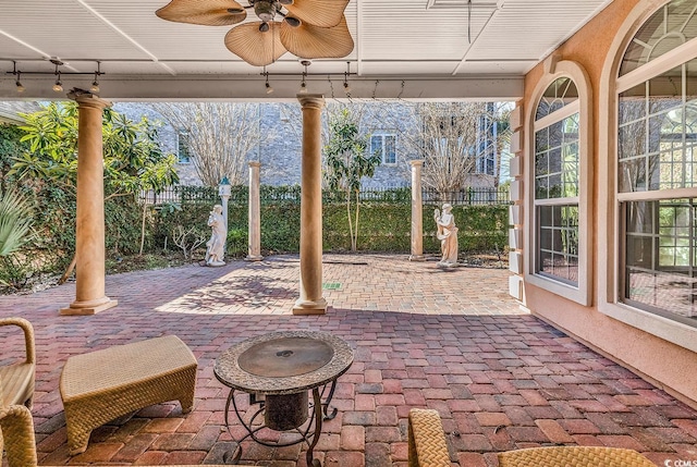 view of patio with a ceiling fan and fence