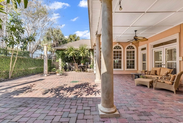 view of patio / terrace featuring an outdoor living space, ceiling fan, and fence