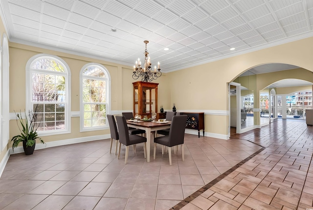 dining room with light tile patterned floors, baseboards, and an inviting chandelier