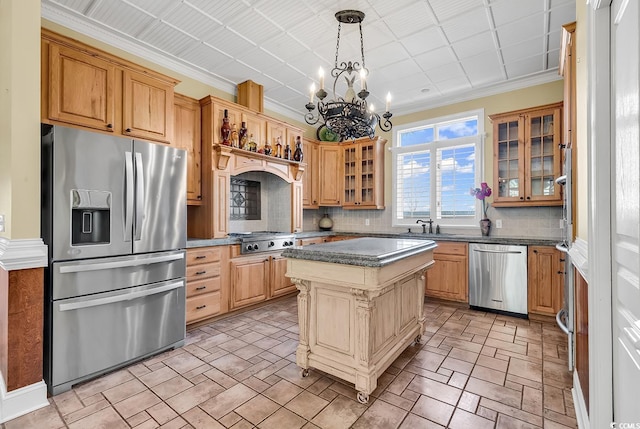 kitchen featuring ornamental molding, decorative backsplash, a sink, glass insert cabinets, and appliances with stainless steel finishes