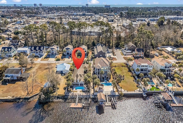 drone / aerial view featuring a residential view and a water view