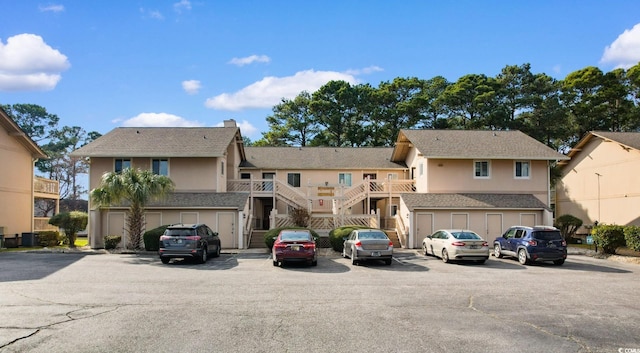 exterior space featuring stairs, a residential view, and uncovered parking