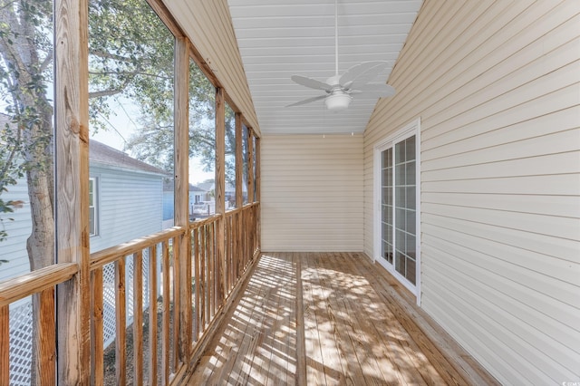 unfurnished sunroom with a ceiling fan