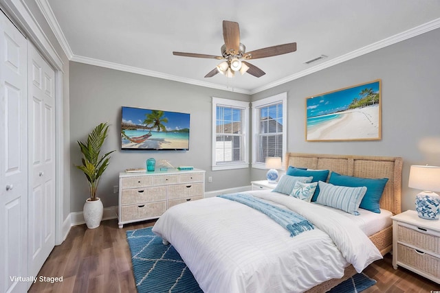 bedroom with baseboards, visible vents, ornamental molding, dark wood-type flooring, and a closet