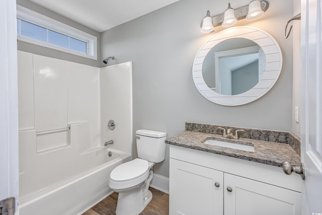 full bathroom with toilet, vanity, shower / tub combination, wood finished floors, and baseboards