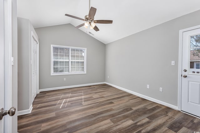 interior space with dark wood-style floors, visible vents, vaulted ceiling, and baseboards