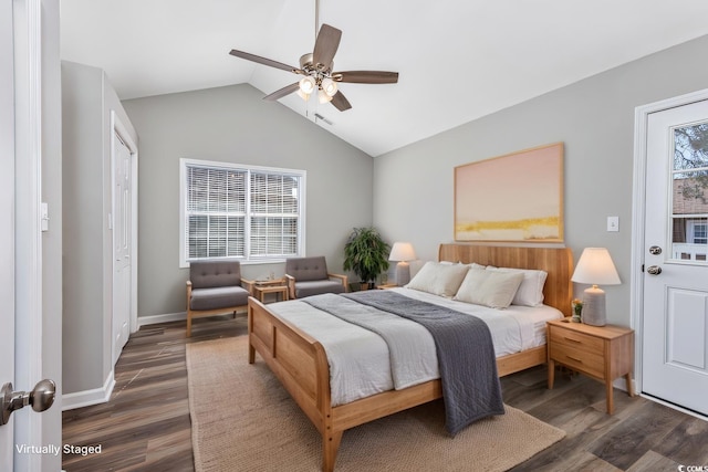 bedroom featuring vaulted ceiling, multiple windows, and wood finished floors