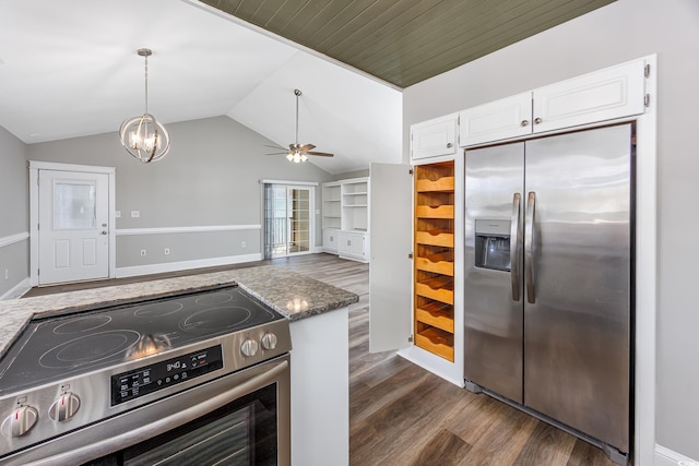 kitchen featuring lofted ceiling, ceiling fan with notable chandelier, stainless steel appliances, white cabinets, and dark wood-style floors