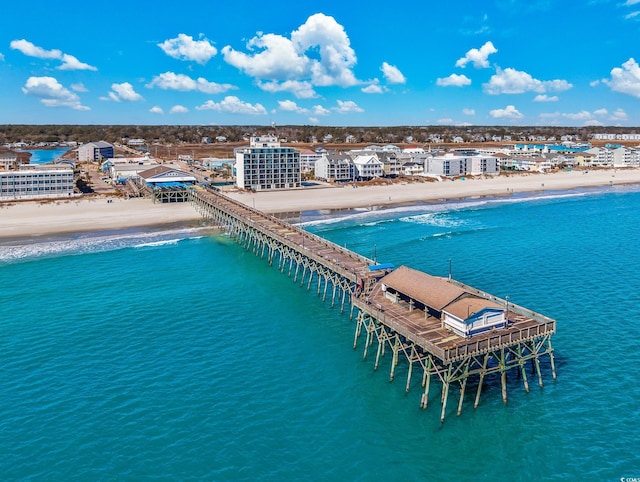 birds eye view of property with a water view and a view of the beach