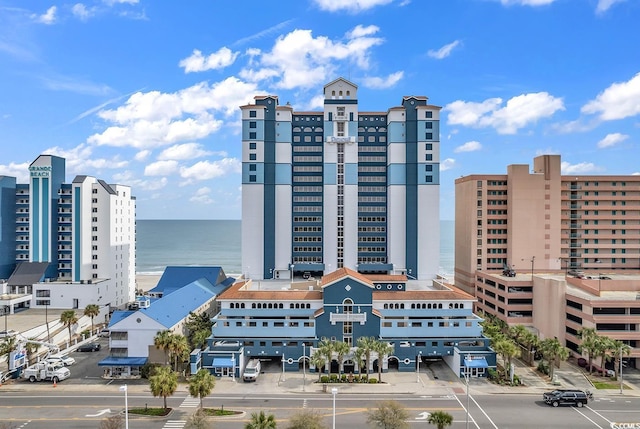 exterior space with a city view and a water view