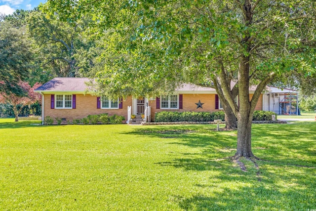 ranch-style house featuring brick siding, crawl space, and a front yard