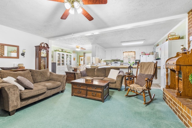 carpeted living room with a ceiling fan and a textured ceiling