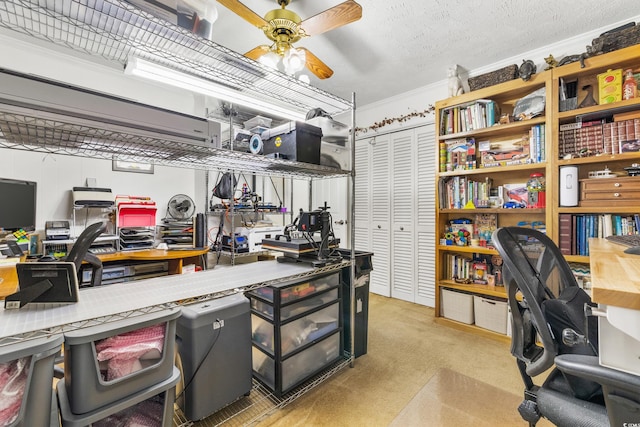 office area featuring a ceiling fan, carpet, and a textured ceiling