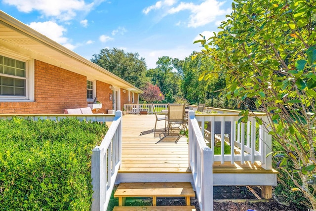 wooden deck featuring outdoor dining area