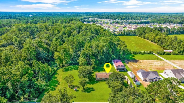 birds eye view of property with a view of trees