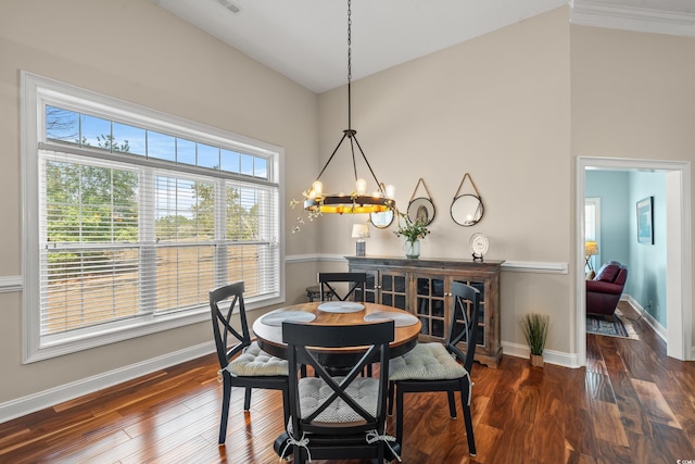 dining space with a chandelier, wood finished floors, and baseboards