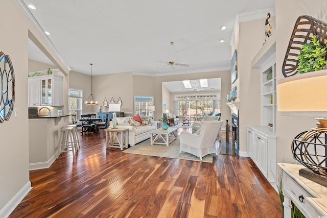 living room featuring plenty of natural light, ornamental molding, and dark wood finished floors