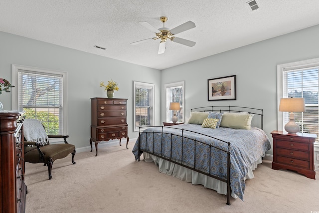 bedroom with ceiling fan, carpet flooring, visible vents, and baseboards