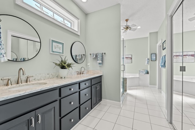 full bathroom with tile patterned flooring, a shower stall, a bathtub, and a sink