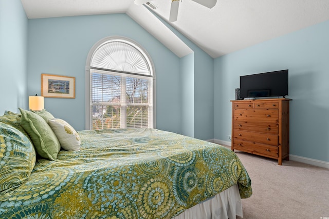 carpeted bedroom featuring visible vents, baseboards, vaulted ceiling, and a ceiling fan