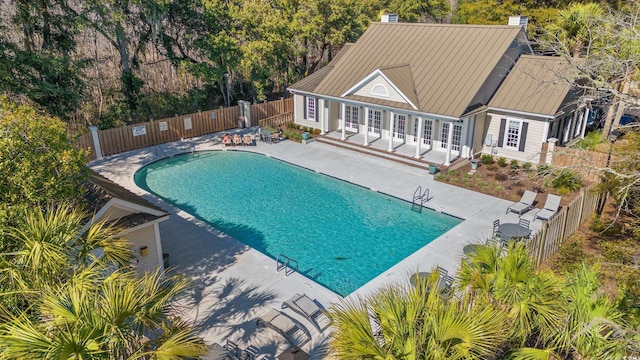 pool featuring a patio area and fence