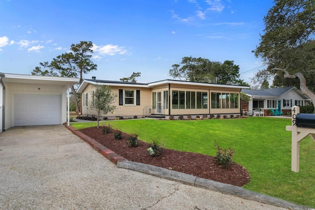 ranch-style house featuring gravel driveway, a front yard, and a garage