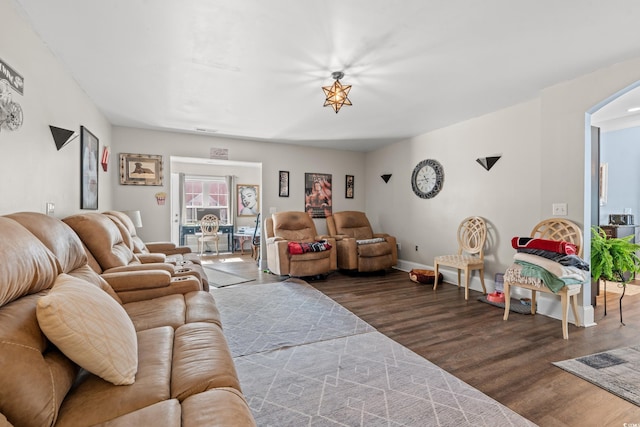 living area featuring dark wood-type flooring and baseboards