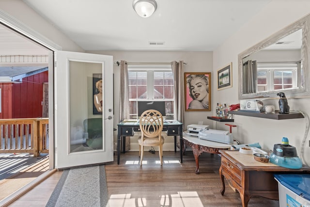 office featuring visible vents and wood finished floors