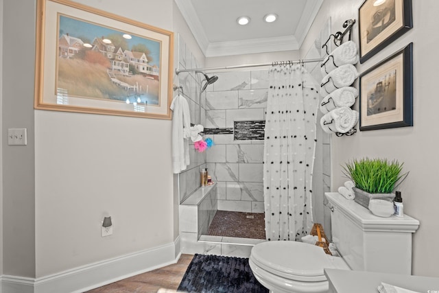 bathroom featuring baseboards, toilet, wood finished floors, a tile shower, and crown molding