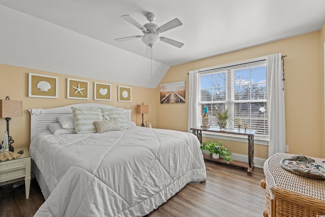 bedroom with lofted ceiling, a ceiling fan, baseboards, and wood finished floors