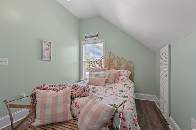 bedroom with lofted ceiling, baseboards, and wood finished floors