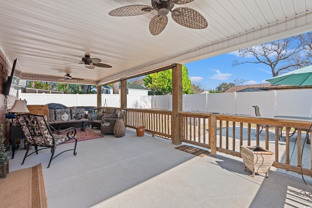 view of patio / terrace featuring ceiling fan, an outdoor living space, and a fenced backyard