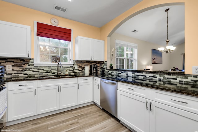 kitchen with dark stone counters, visible vents, white cabinetry, backsplash, and dishwasher