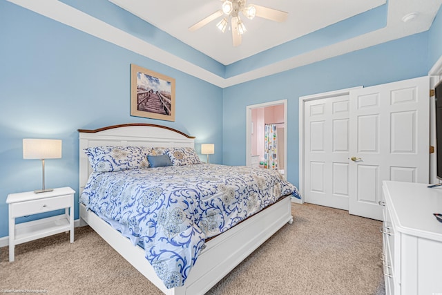 bedroom featuring light carpet, ceiling fan, and baseboards