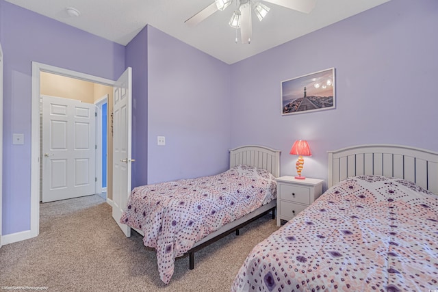 carpeted bedroom featuring ceiling fan and baseboards