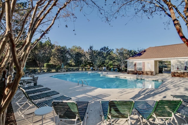 pool featuring a patio and fence