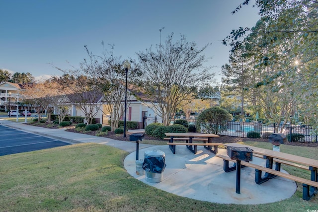 view of home's community featuring a lawn, fence, and a residential view