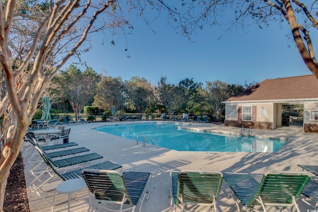 community pool featuring a patio area and fence